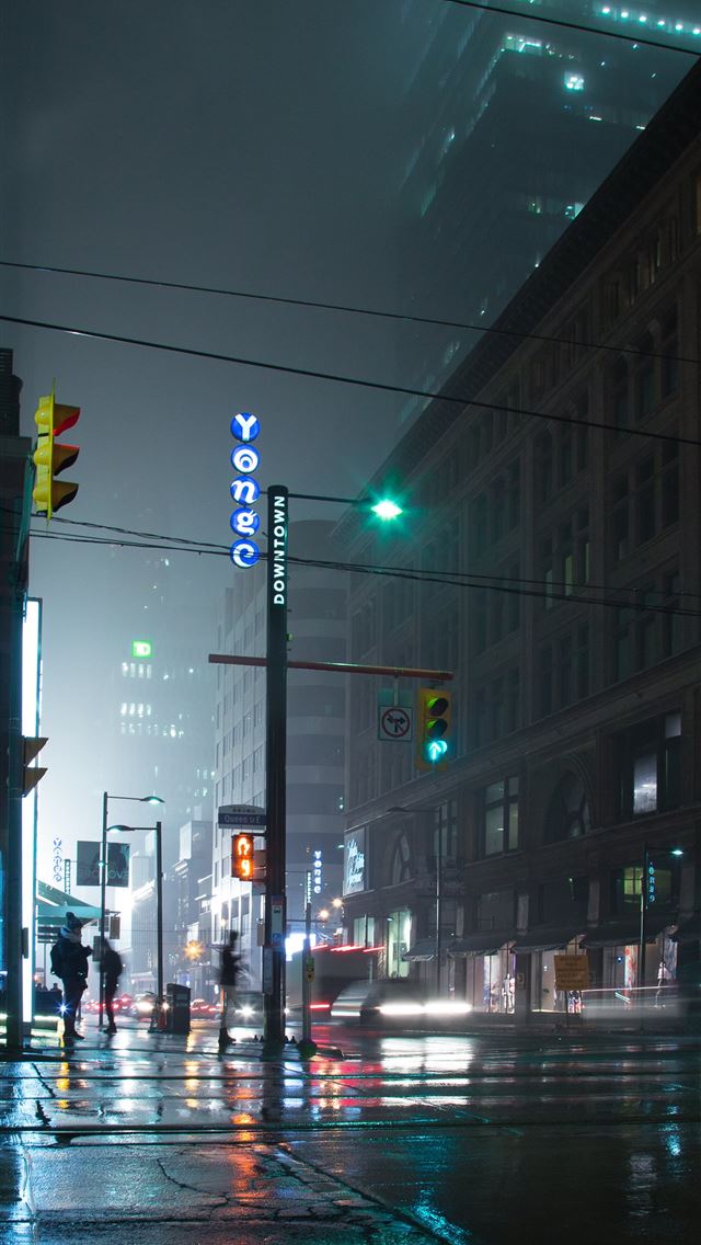people standing near lamp post and building